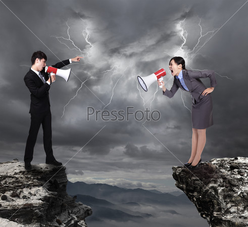 business Man and woman shouting to each other through megaphone on danger precipice on the mountain with rainstorm clouds and lightning