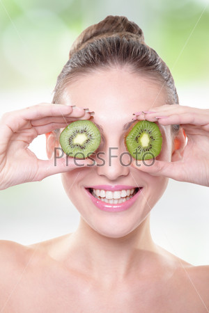 Kiwi. Healthy fruit funny woman holding kiwi fruit for her eyes