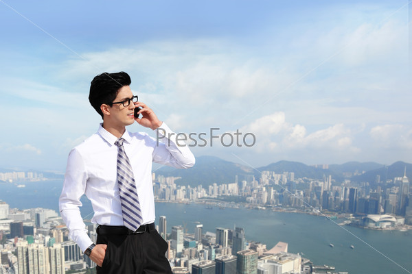 Happy business men call by smart phone on business architecture background, asia, hong kong