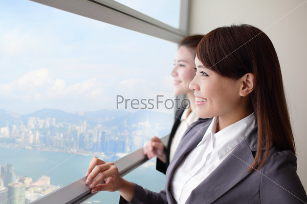 Business woman looking through a window with city background, asia, hong kong, asian