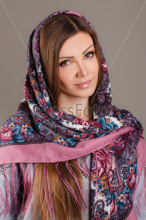 beautiful oriental look. portrait of a beautiful young woman with a scarf on her head. Russian beauty. Russian national traditional scarf on head.