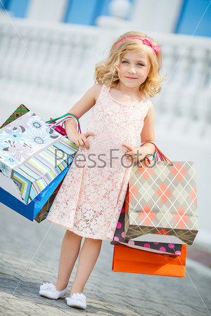 Little girl fashion with packages at the Mall.