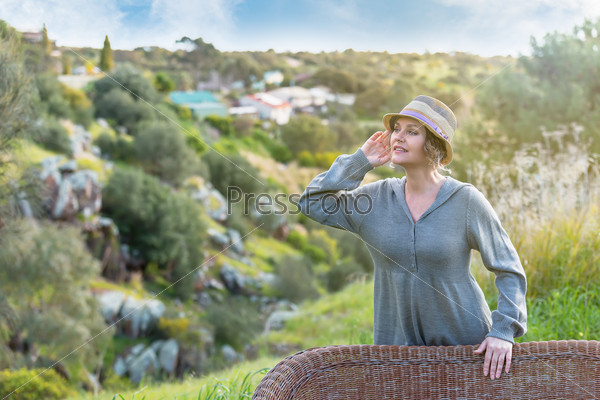 Woman  in hat listening sound in nature