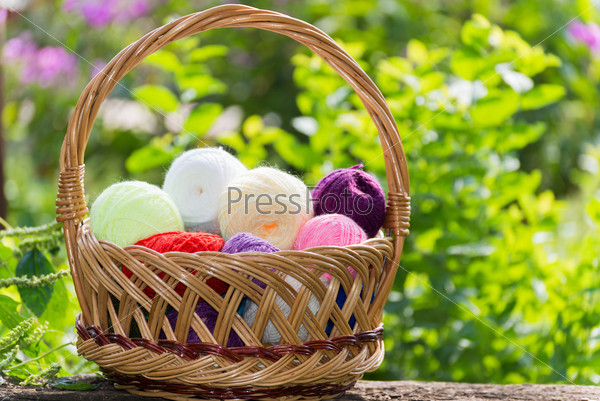 Wicker basket with colorful balls of  yarn