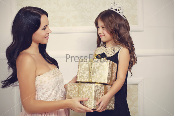 Portrait of luxury family with gold gift boxes