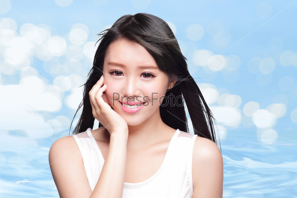 Beauty Skin care concept, Beautiful woman face and long hair with Water splashes isolated on blue background, asian model