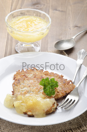 potato pancake with bramley apple sauce and parsley on a plate
