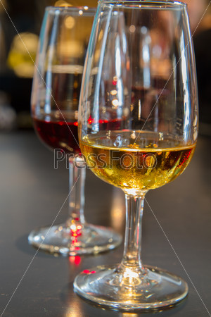 set of glasses of white and ruby port wine