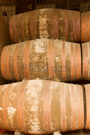 rows of traditional  aged  wooden port  wine barrels close up