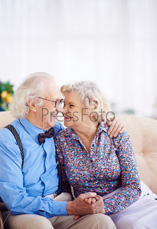 Elegant retired couple looking at one another