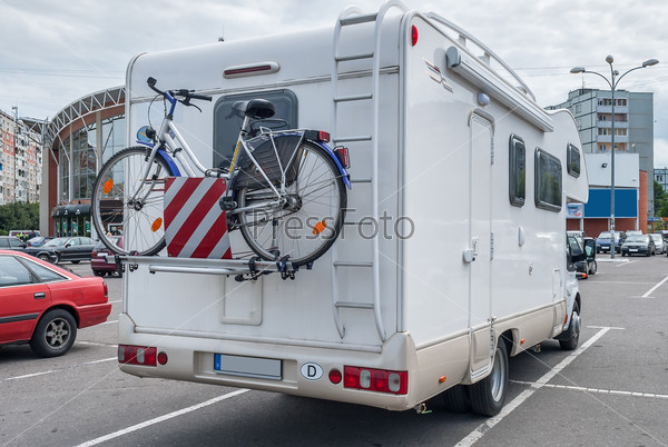 Camper with bicycle in city