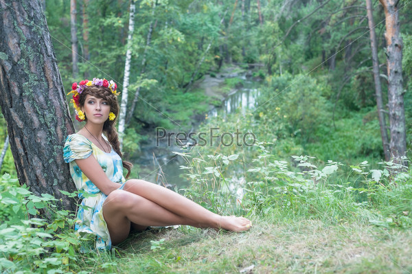 Attractive Woman Portrait with Wreath of Flowers. Natural Beauty
