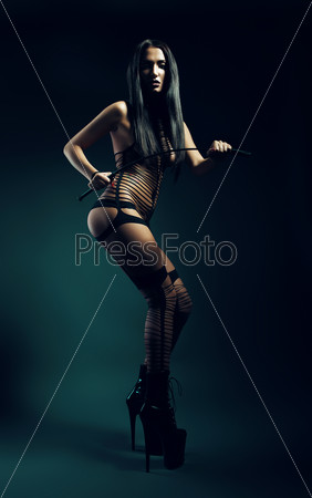 bdsm woman in black wear with whip