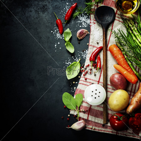 Wooden spoon and ingredients on dark background