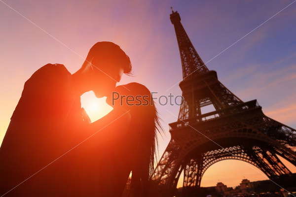 silhouette of romantic lovers with eiffel tower in Paris with sunset