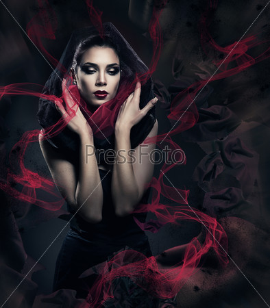 Beautiful woman in black hood with abstract fabric