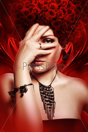 woman with hand on face and hat of red roses
