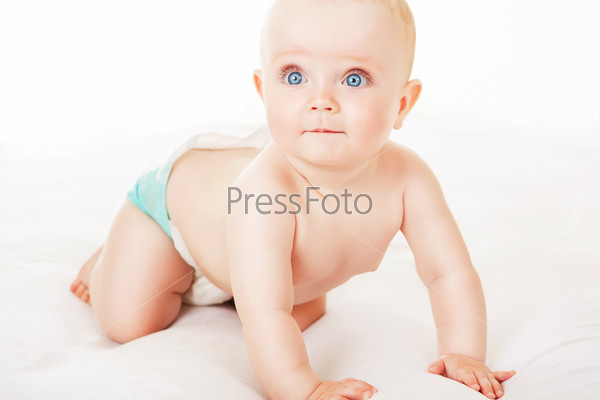 little child with blue eyes on white fabric