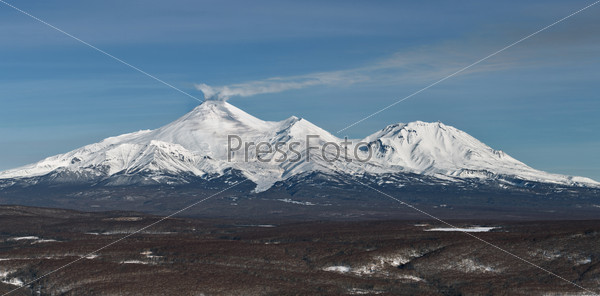 Panorama view of the volcanoes fumarolic activity - throw gas and ash. Russia, Far East, Kamchatka Peninsula.
