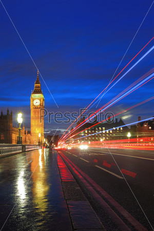 Big Ben and London at night with the lights of the cars passing by after rain, the most prominent symbols of both London and England