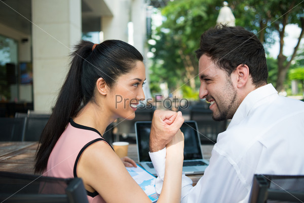 Business woman and man wrestling during the meeting