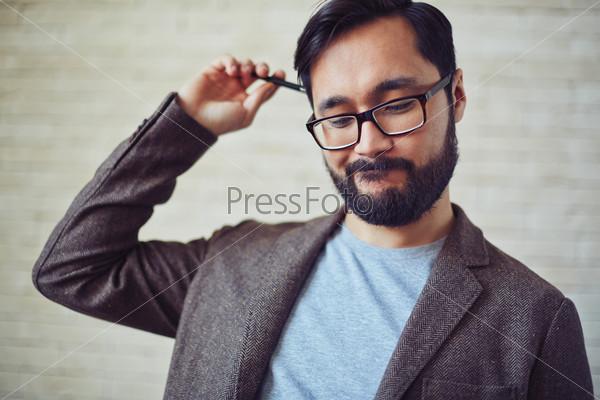 Handsome businessman in eyeglasses doubting about something