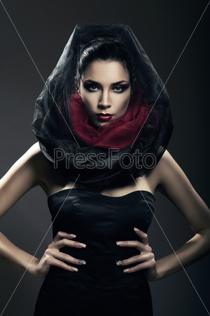 hot mysterious woman in black hood in dark