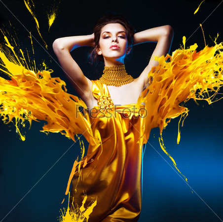 woman in yellow dress and mask with jewelry