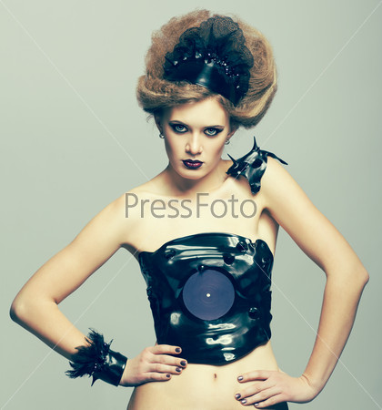 Woman in dress and diadem made of molten vinyl disk