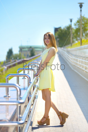 Attractive girl in a yellow dress