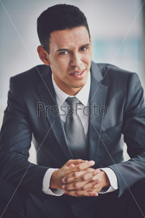 Confused businessman looking at camera