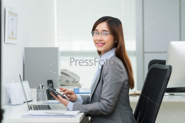 Portrait of Vietnamese female accountant working in the office