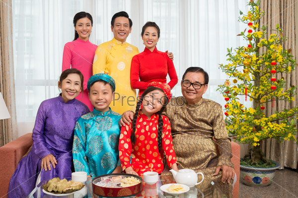 Portrait of happy big Vietnamese family in national costumes