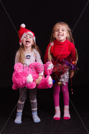 Two girls grimace and show language in Christmas clothes