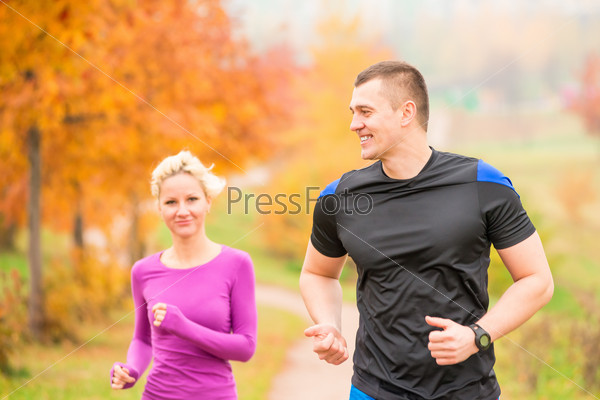 Healthy lifestyle - jogging. a man and a woman running in the morning in the park, stock photo