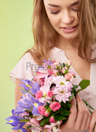 Gorgeous girl looking at floral bouquet