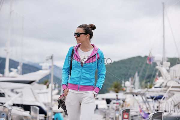 relaxed young woman walking in marina