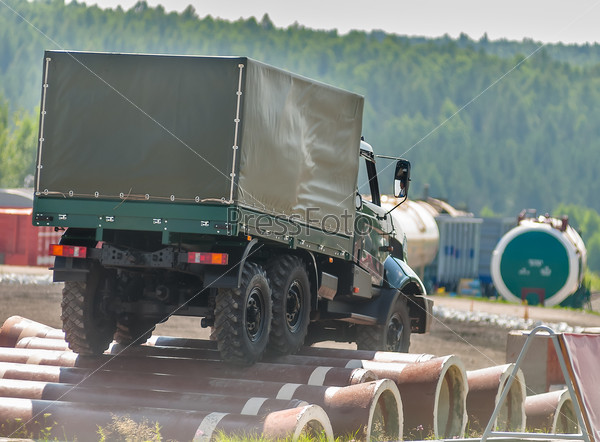 Nizhniy Tagil, Russia - July 12. 2008: Curtain sided truck Ural moves on an obstacle from pipes. Display of opportunities of arms and military equipment. RAE exhibition, stock photo