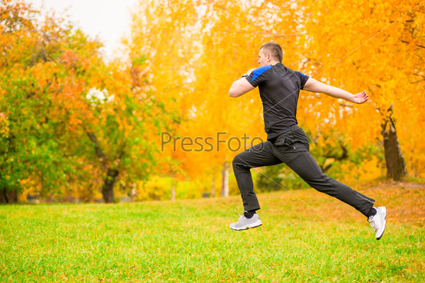 man in sportswear jumps high during exercise