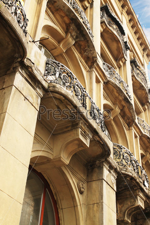 Historic building with balconies with wrought iron railings, Lviv