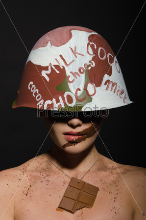 Beautiful woman with chocolate helmet, camouflage and badge on the neck