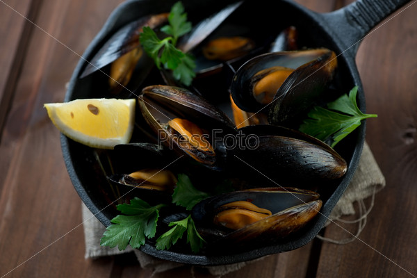 Above view of steamed mussels in a frying pan, studio shot
