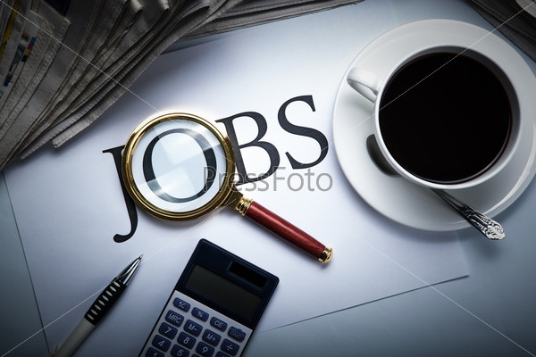 title jobs with loupe, pen, newspapers, cup of coffee and calculator