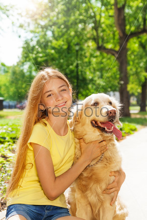 Teenage blonde girl with retriever dog otside