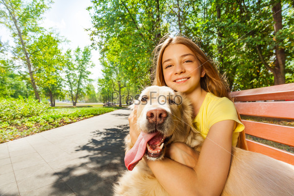 Close portrait of the teenage girl with happy dog