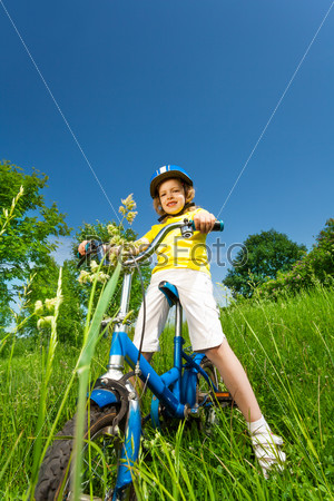 Little girl in yellow shirt on a bike