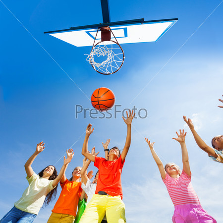 Children playing basketball view from bottom