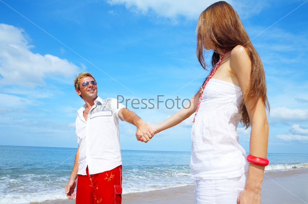 A portrait of attractive couple having fun on the beach, stock photo