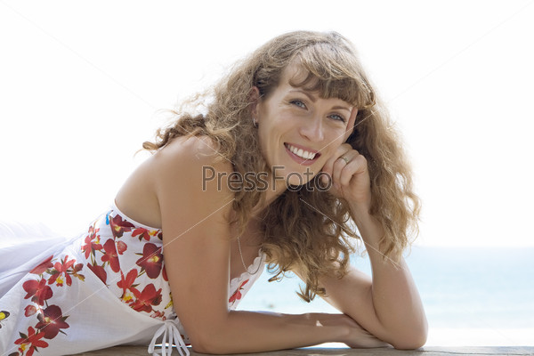 Portrait of nice young woman having good time on the beach