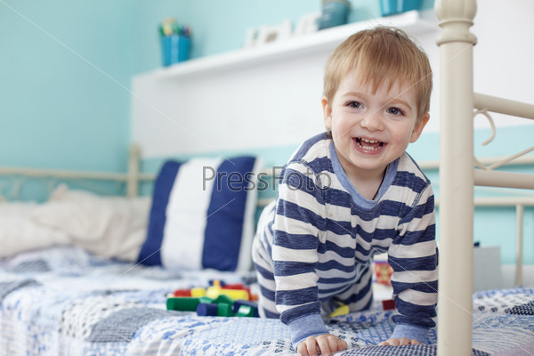2 years old toddler playing with toys at the bedroom